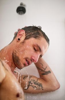 Feel fresher by the drop. a handsome young man having a shower.
