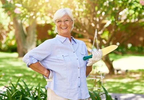 The garden is my domain. Portrait of a happy senior woman enjoying a bit of gardening.