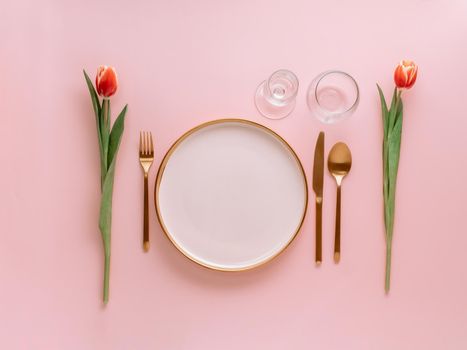 Pink festive table setting on pink, copyspace