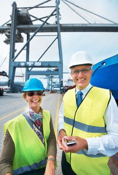 Logistics, supply chain and ship engineer or workers on the dock smiling while working in delivery industry. Cargo and shipping Portrait of happy and smiling stock managers working in export business