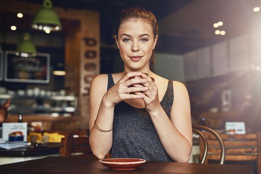 This is the spot to get your caffeine fix. a young woman having a cup of coffee in a cafe.