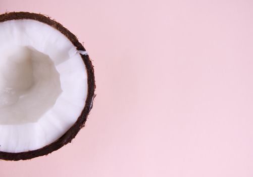 Halved of sweet tasty raw vegan coconut isolated on pink with advertising copy space. Healthy eating. Food background