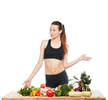 Theyre packed with all the nutrients you need. Studio portrait of an attractive young woman posing with a table full of vegetables against a white background.
