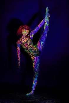 Life in neon. Full length shot of a young woman posing with neon paint on her face.