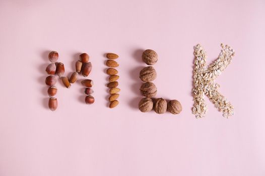 Lettering the word Milk, using various healthy wholesome nuts and cereals, on pink background with copy advertising text