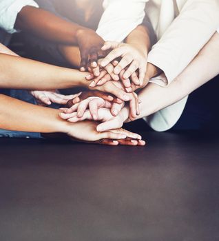 We know we can count on each other. unrecognizable businesspeople joining their hands together in unity.
