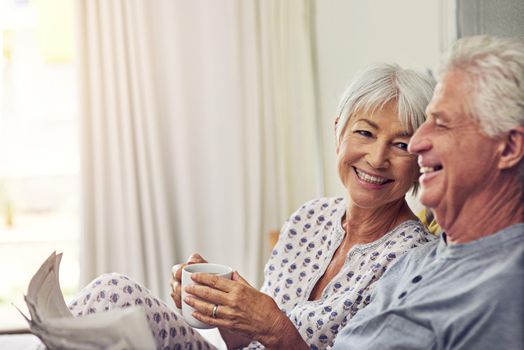 Couples who laugh together, stays together. a senior couple lying in bed.