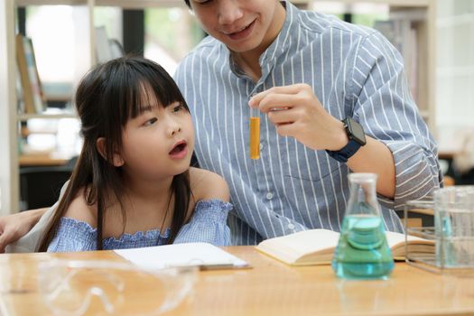 Kid and father doing science experiments. Education science concept