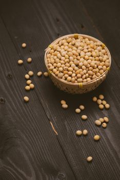 Soy beans in bowl on wooden background