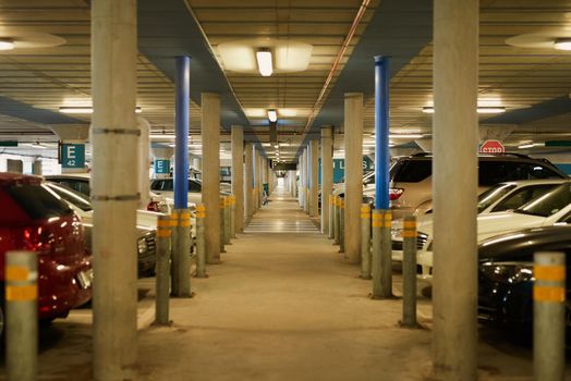 Your car is safe and sound. an underground parking garage full of cars.