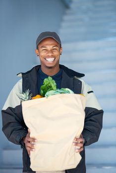 I told you we deliver anything and everything. Portrait of a courier making a grocery delivery.