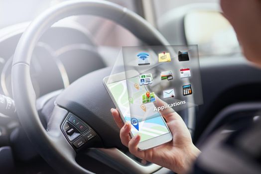 Information at your fingertips. a person in a car using their phone to find directions.