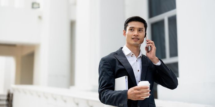 Handsome Asian businessman calling on smartphone. close up.