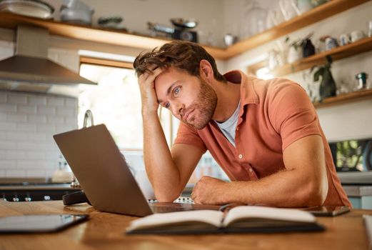 Stress, laptop finance and planning man thinking of home loan, investment savings and future money growth goals in house kitchen. Anxiety, burnout or sad guy with debt depression after trading budget
