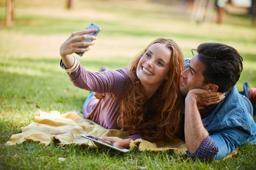 Nothing makes a good picture like love does. Portrait of a young couple taking a selfie while out at the park.