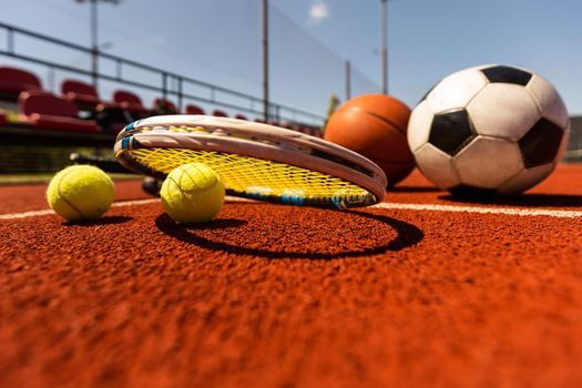Set of sport equipment, rackets and tennis balls soccer and basketball balls