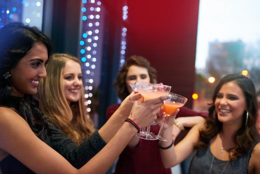 The fun starts now. a group of young women celebrating with cocktails at a party.