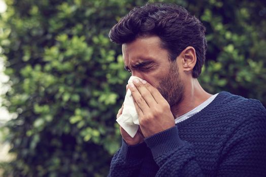 Its the season of sneezes. a young man suffering with allergies.