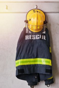 Ready for an emergency. firemens clothing hanging from a wall.