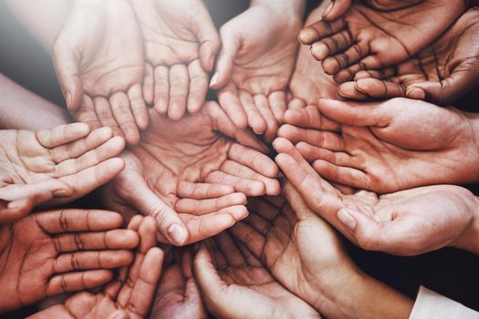 Help those in need. a group of hands held cupped out together.