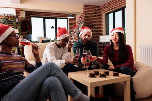 Coworkers clinking glasses of wine at xmas office event
