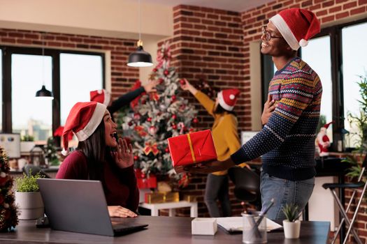 African american man giving gift to colleague