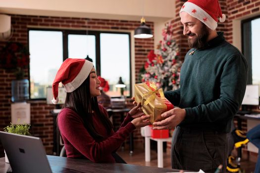 Business man giving christmas gift to woman