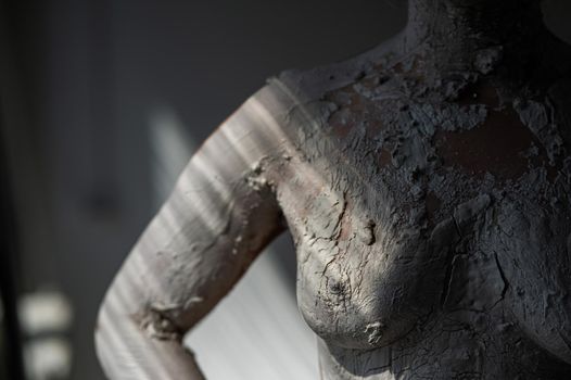 Women's naked breasts covered with plaster like a statue.