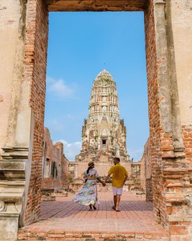 Ayutthaya, Thailand at Wat Ratchaburana, couple men and women with a hat visiting Ayyuthaya Thailand