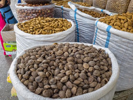 Oriental Bazaar. Almond peeled and unpeeled, nuts sales in market. Dry food, variety almonds in store. Concept of healthy eating, raw product, bazaar, diet, almond theme