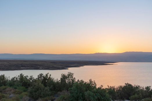 Orange sunrise reflecting off of the Dead Sea.