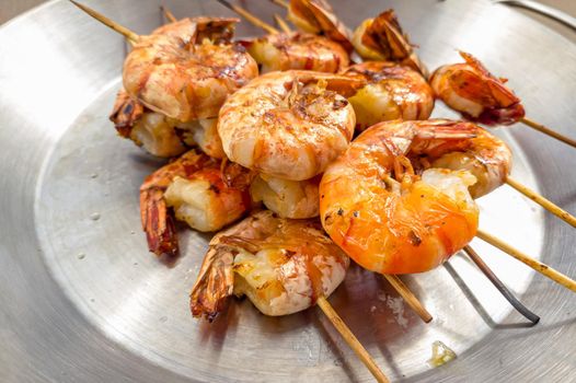 Grilled prawns on wooden skewers, shrimp kebab