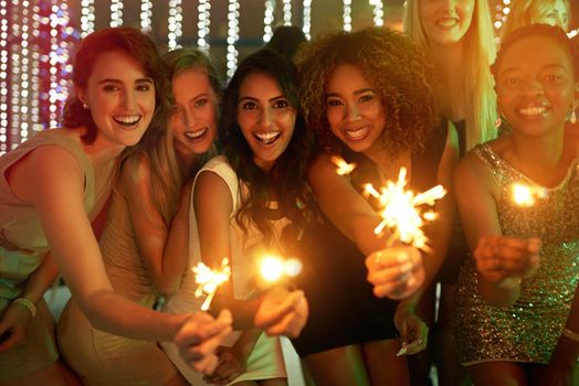 Girls just wanna have fun. a group of girlfriends having fun with sparklers on a night out.