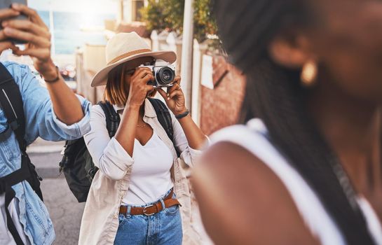 Travel, tourism and photograph with a woman tourist taking a picture while on holiday, vacation or weekend getaway. Memories, sightseeing and overseas with a young female using a camera abroad