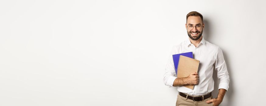 Young handsome man holding notebooks, concept of e-learning and courses