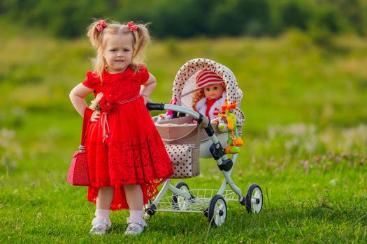 girl playing with a doll in a stroller