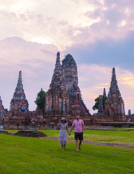 Men and Women with hat tourist visit Ayutthaya, Thailand at Wat Chaiwatthanaram during sunset