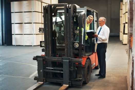 Manager planning forklift logistics with factory employee for supply chain, industrial shipping and warehouse manufacturing. Cargo truck machine for industry container, production and freight storage