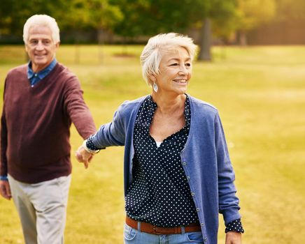Having fun is the secret to forever love. a happy senior couple going for a walk in the park.