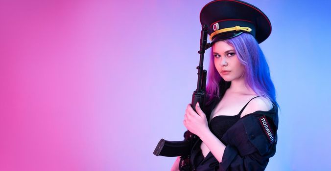 A sexy girl in a military or police uniform poses with a Kalashnikov assault rifle on a neon background
