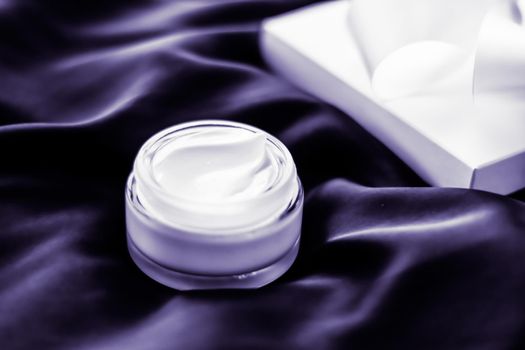 Luxury moisturizing face cream with lavender scent on violet silk, skincare beauty