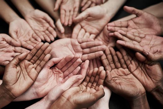 We cant help everyone, but everyone can help someone. a group of hands held cupped out together.