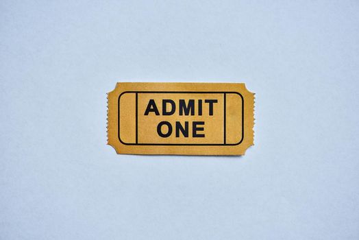 This is where the fun starts. a yellow movie ticket isolated on white.