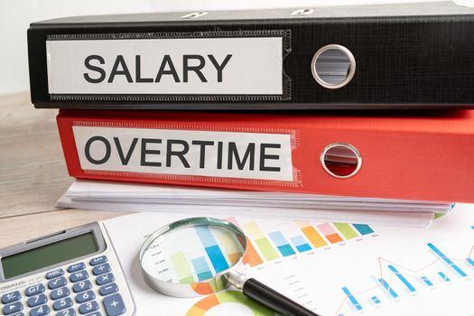 Salary overtime. Binder data finance report business with graph analysis in office.