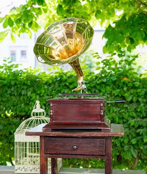 Classical gramophone standing on the background of the street