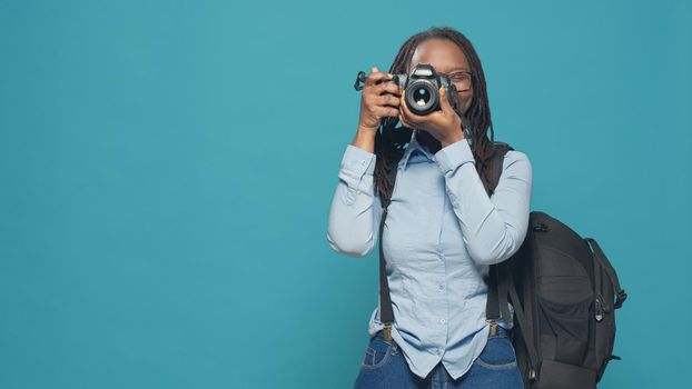 African american woman capturing image with camera