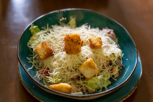 meat beautifully decorated Caesar salad with grated cheese, croutons
