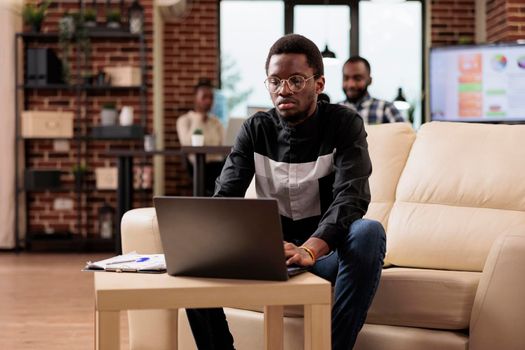 African american man working on laptop pc
