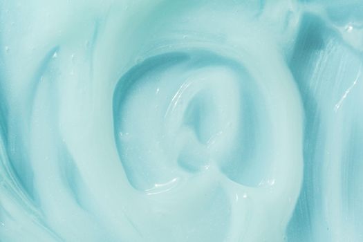 Blue cream, moisturizer, shampoo spread, sunscreen cosmetic smear background. Moisturizing beauty creme, balm swatch, paint texture. Creamy fluid skincare lotion mousse