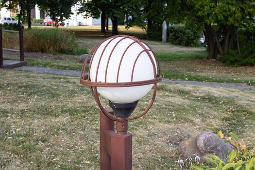 Rusty street lamp in the park closeup